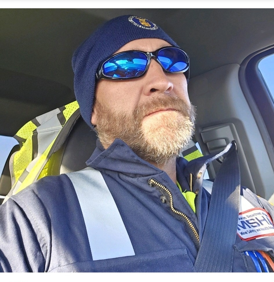 Scott Chest wearing an MSHA jacket and seat belt in a vehicle.